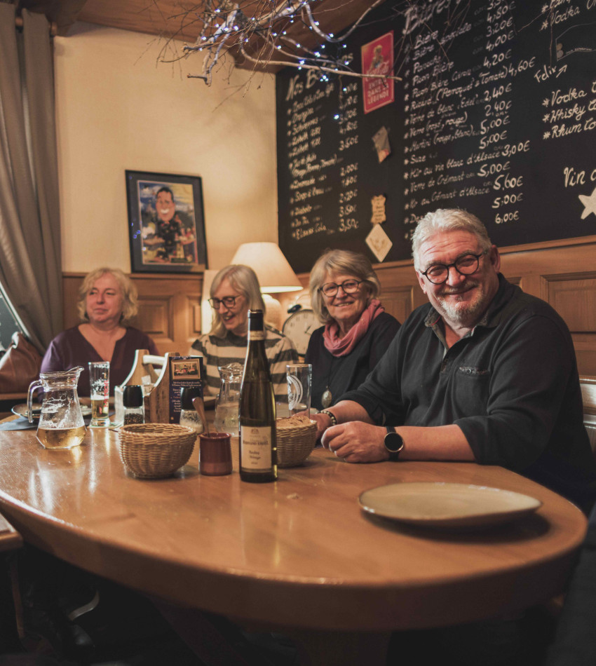 Gesellige Runde am Stammtisch. Auf der Tafel stehen die Angebote des Tages